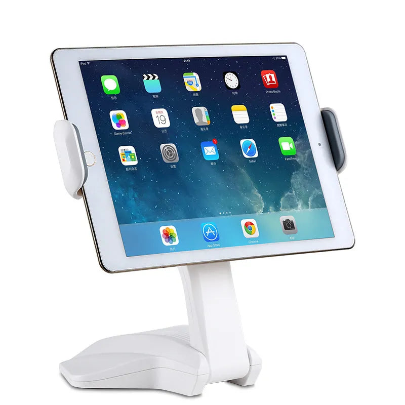 White adjustable tablet stand with a wide clip, holding a tablet on a table.