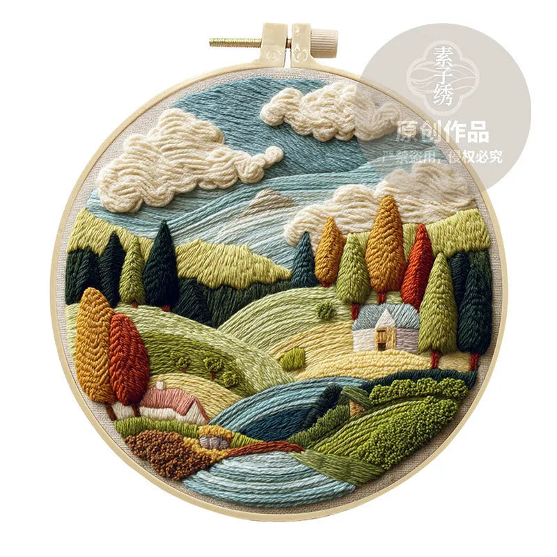 Embroidery DIY kit with cotton fabric, bamboo frame, scissors, and printed landscape pattern
