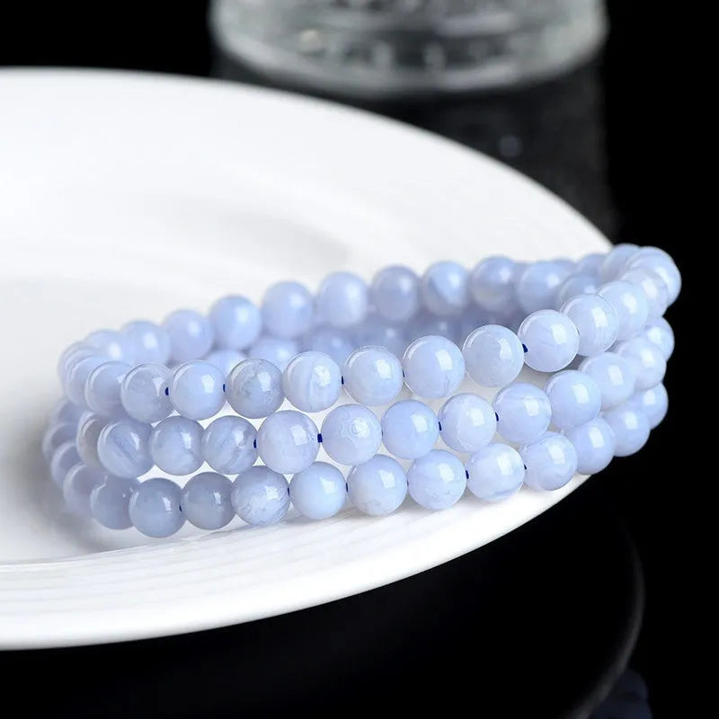 Blue agate beaded bracelet with striped patterning on 6-6.8mm beads in three circular strands