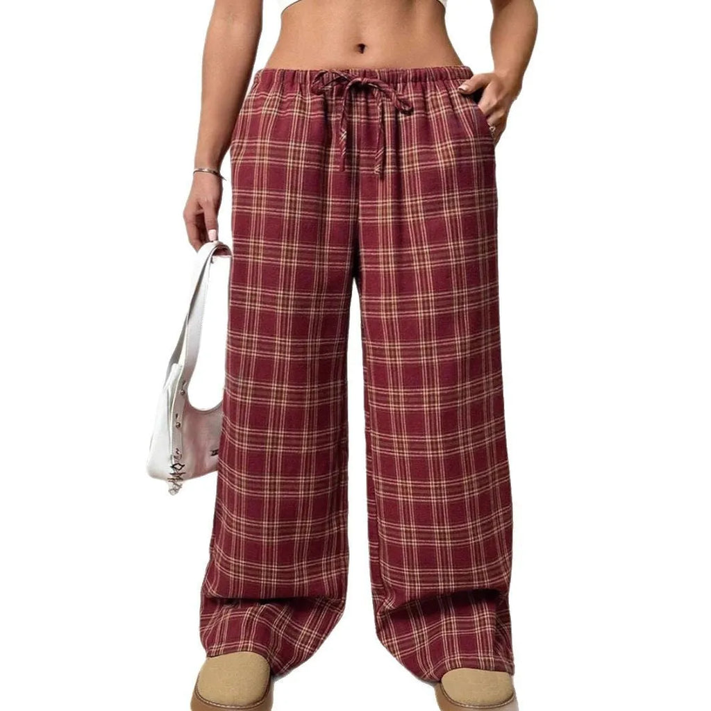 Women's red plaid trousers with drawstring waist and side pockets on mannequin display