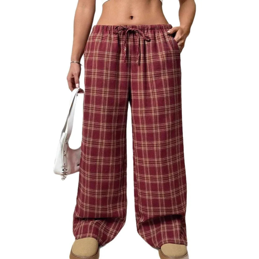 Women's red plaid trousers with drawstring waist and side pockets on mannequin display