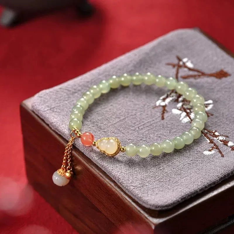 Jade women's bracelet with gold plated gourd charm and fu character decoration