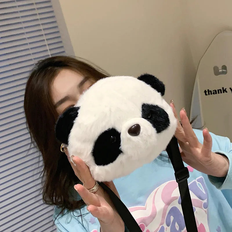 Soft plush panda head crossbody bag with cylindrical shape and sandwich pocket.