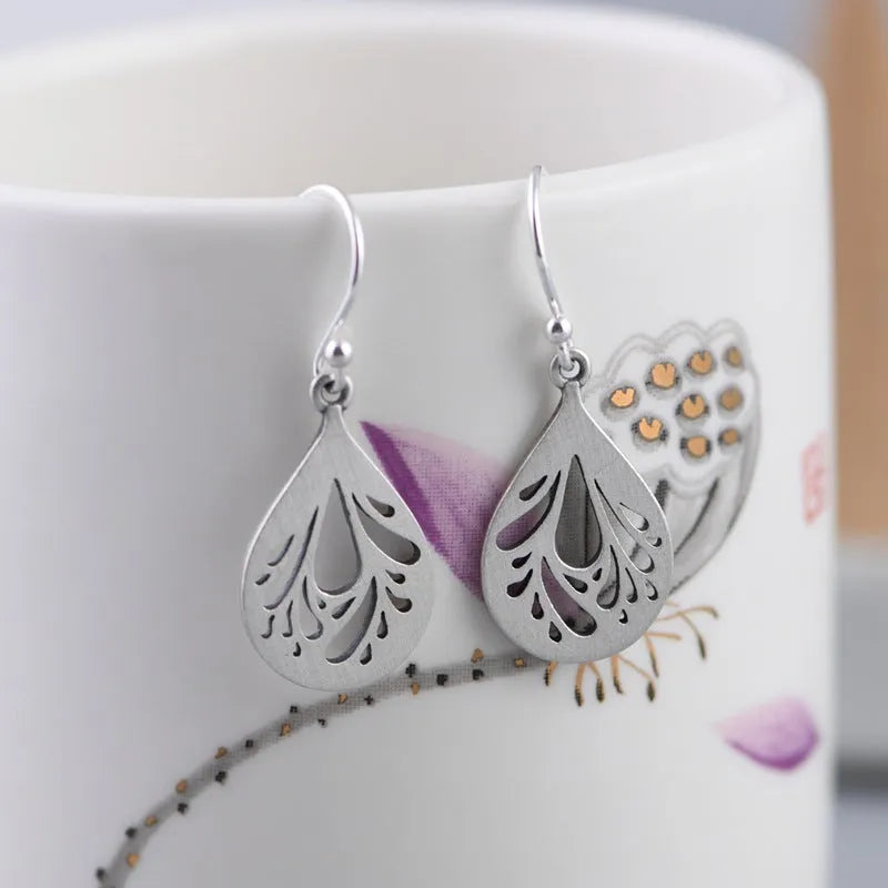 Silver hollow water drop earrings with grinding finish and retro style