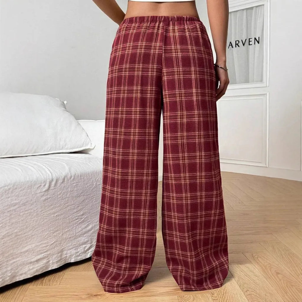 Women's red plaid trousers with drawstring waist and side pockets on mannequin display