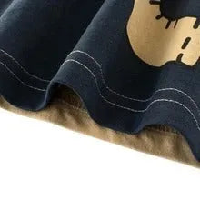 Children's green lion print cotton T-shirt on a hanger, showing crew neck and short sleeves.