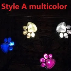 Four black solar-powered bear paw print garden lights with solar panel pole