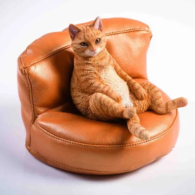 Lazy cat and sofa miniature car dashboard ornament made from resin, approximately 7.5cm high.