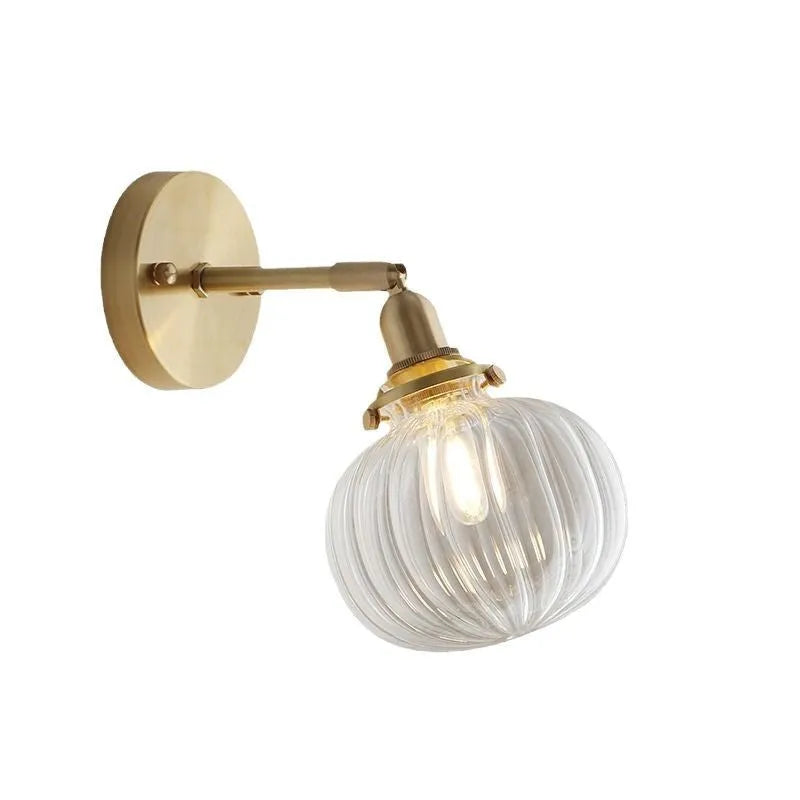 Pumpkin-shaped transparent glass wall lamp for living room or bedroom.