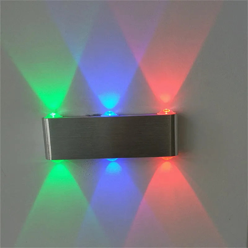 Silver aluminium rectangular LED wall lamp showing seven colour lighting options on bedroom wall