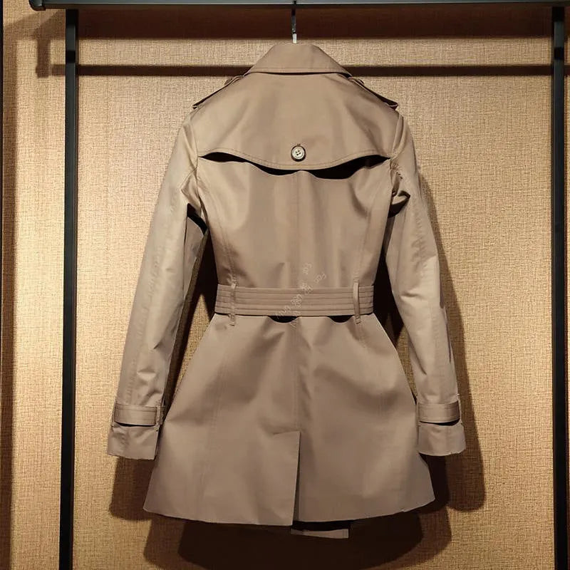 Khaki double-breasted women's trench coat with flight sleeves, shown on a hanger.
