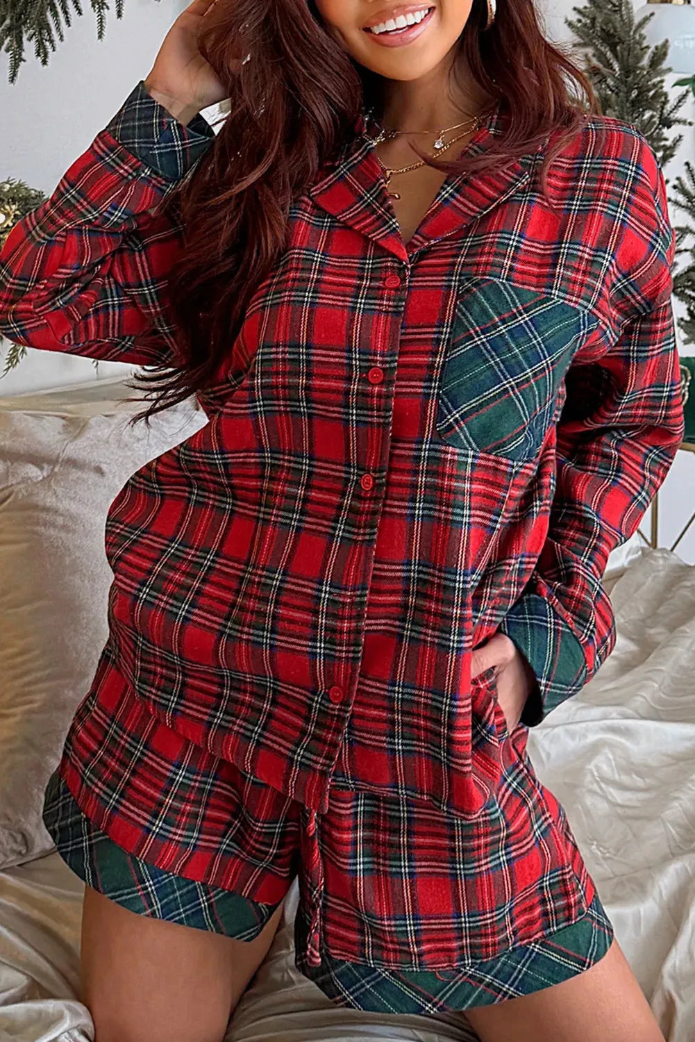 Red plaid two-piece pajama set with long sleeve shirt and shorts featuring contrast patches.