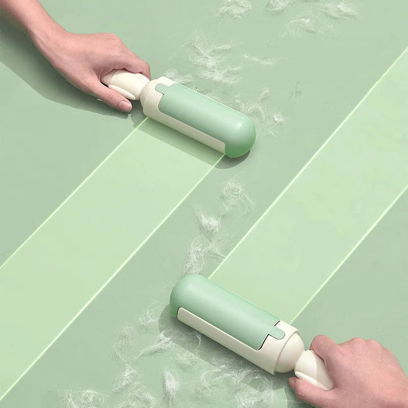 White and green reusable pet hair remover roller with a non-slip handle on a fabric sofa.