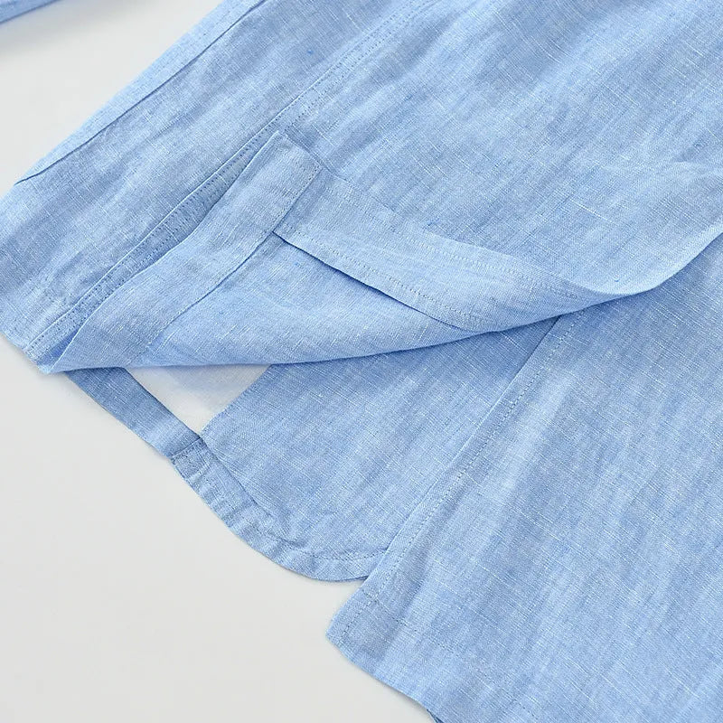 Men's thin linen suit coat in a solid colour on a hanger, showing stick pocket detail.