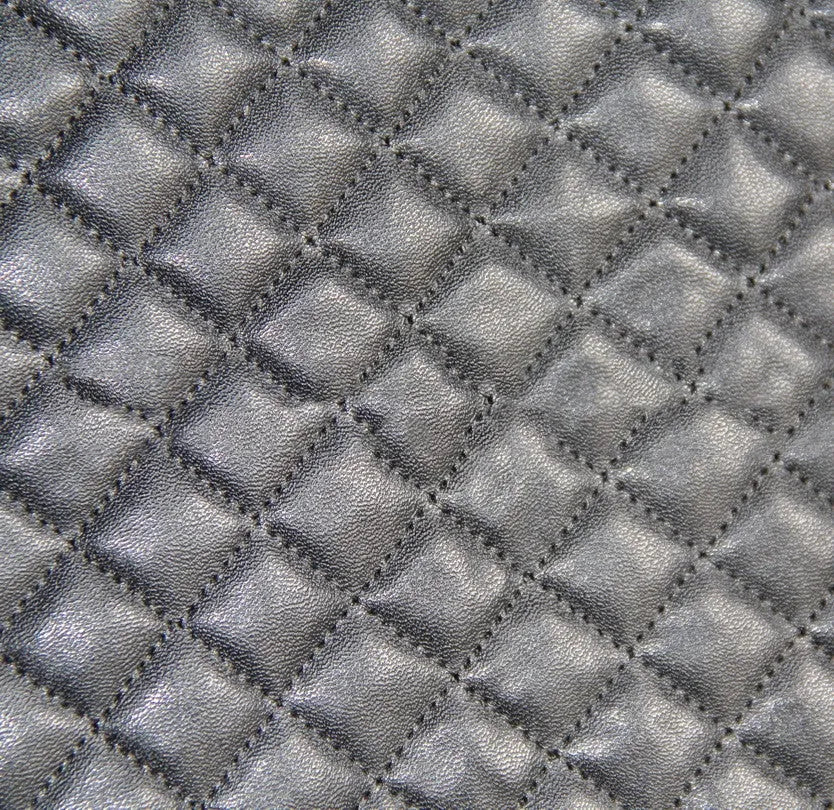 Black quilted universal car seat cover made of PU leather and polyester composite with plastic hooks.