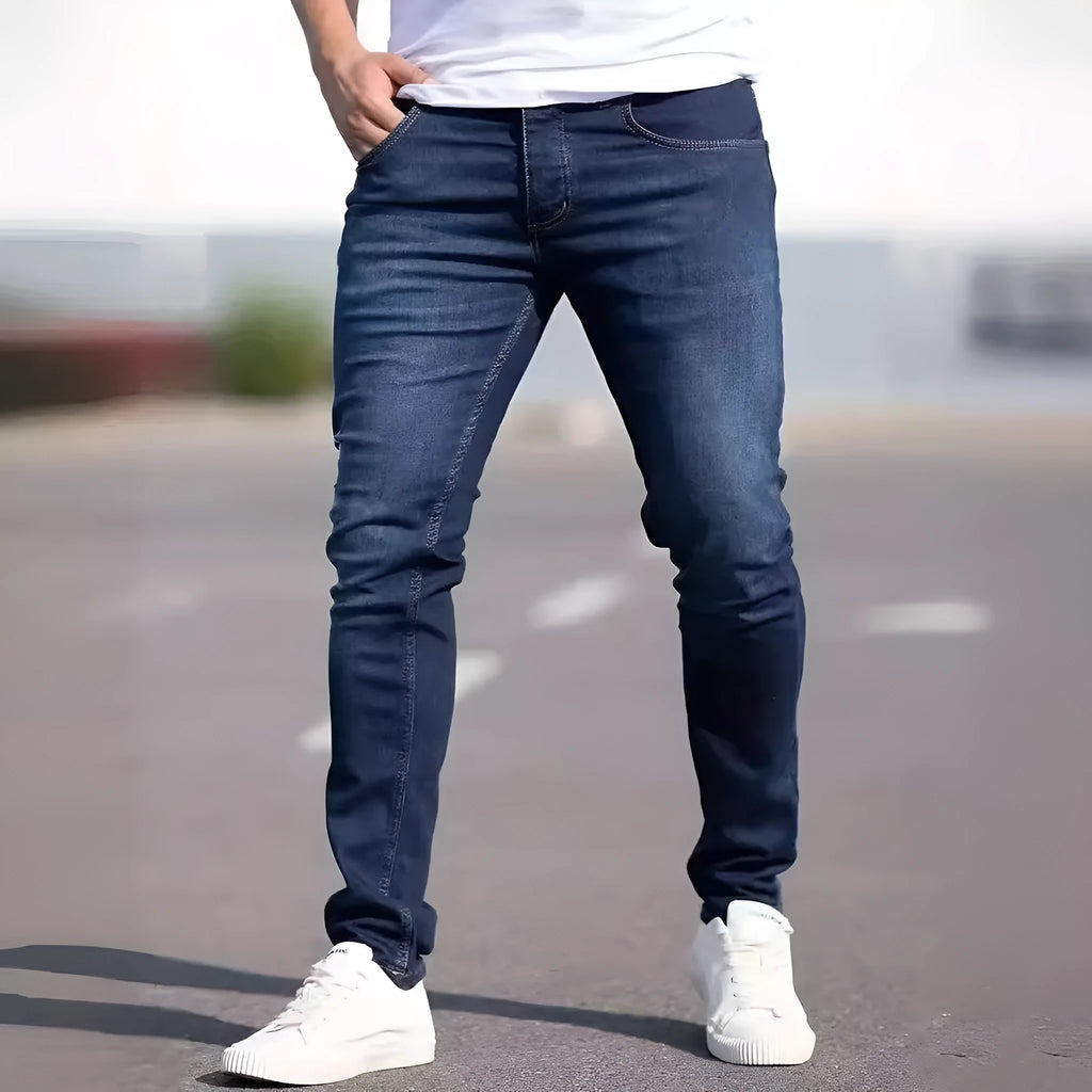 Men's dark blue slim fit casual jeans with a mid-waist and skinny leg style.