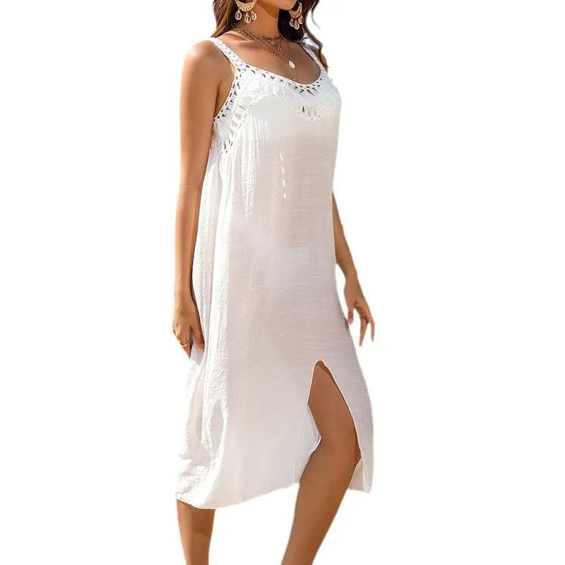 White suspender beach dress with crocheted weaving detail and a bottom slit.