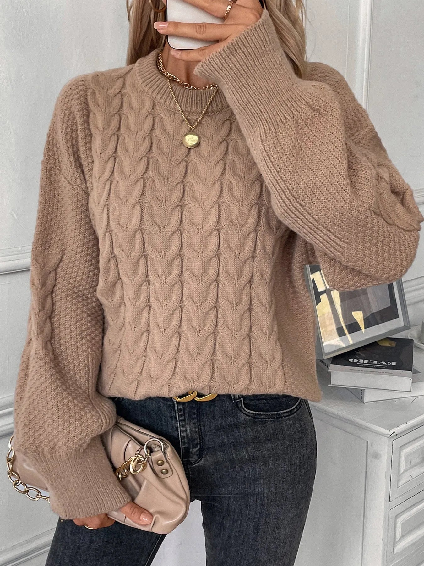 Women's beige casual sweater with a textured twist design and round neck.
