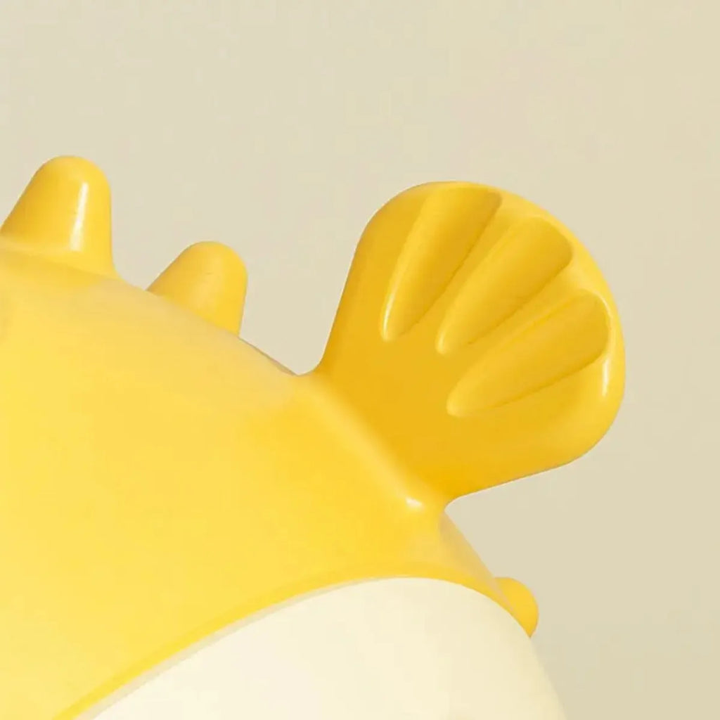 Yellow durable fish-shaped dog chew toy with textured surface for aggressive chewers.