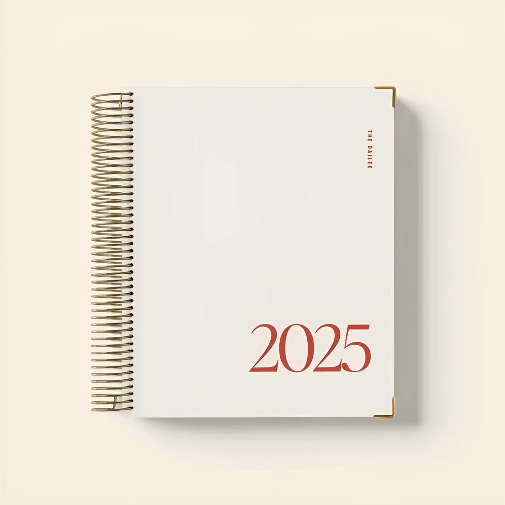 Cherry red A5 daily schedule coil notebook with spiral binding open on desk