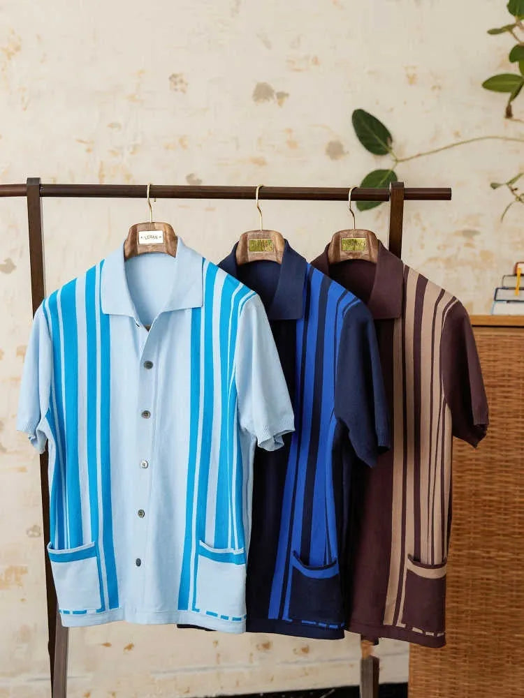 Short-sleeved striped knitted polo cardigan in light blue on a hanger.