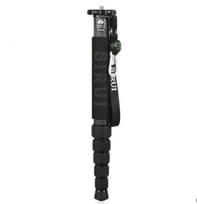 Black carbon fibre telescopic camera monopod fully extended to 1540mm next to an SLR