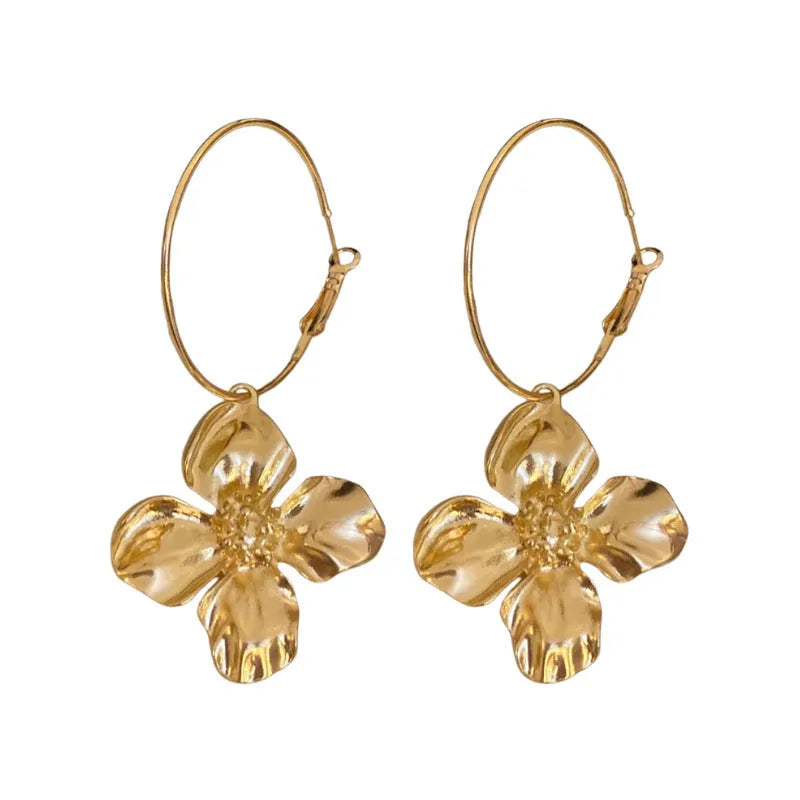 Gold and silver vintage metal flower earrings with geometric design and a silver needle detail.