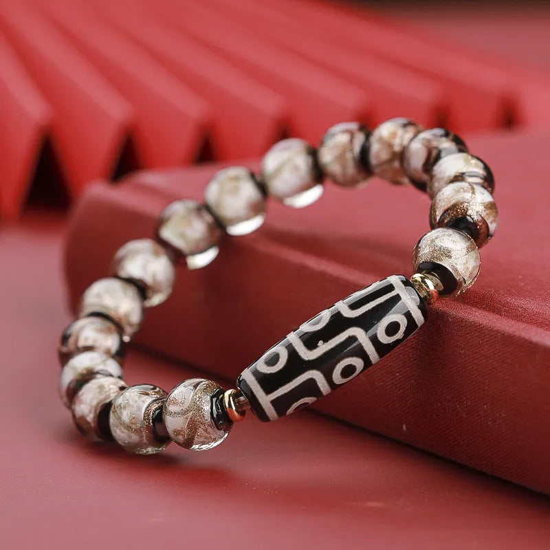 Chinese-style bracelet with coloured glaze beads showing snake and multi-treasure patterns.