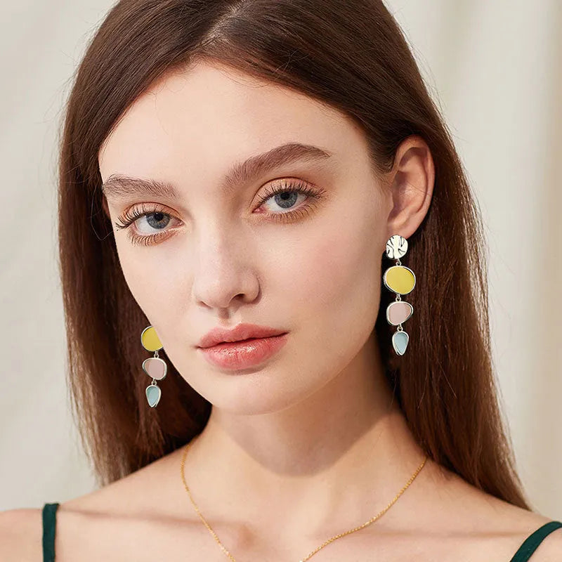 Sterling silver finish Morandi three-colour drip oil wafer disc earrings.