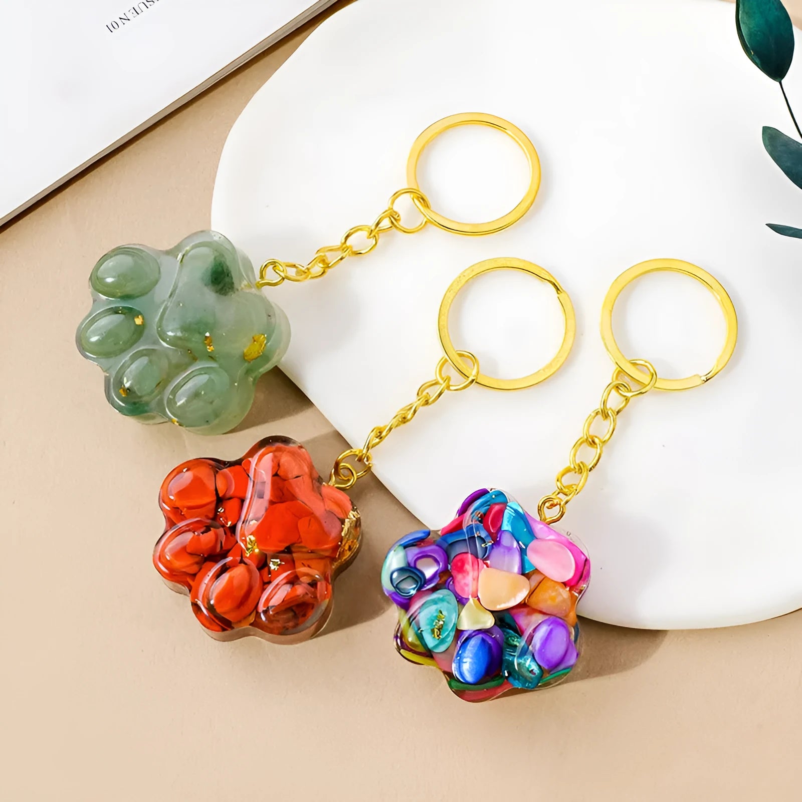 Small metal cat's paw keychain pendant with a set natural crystal charm.
