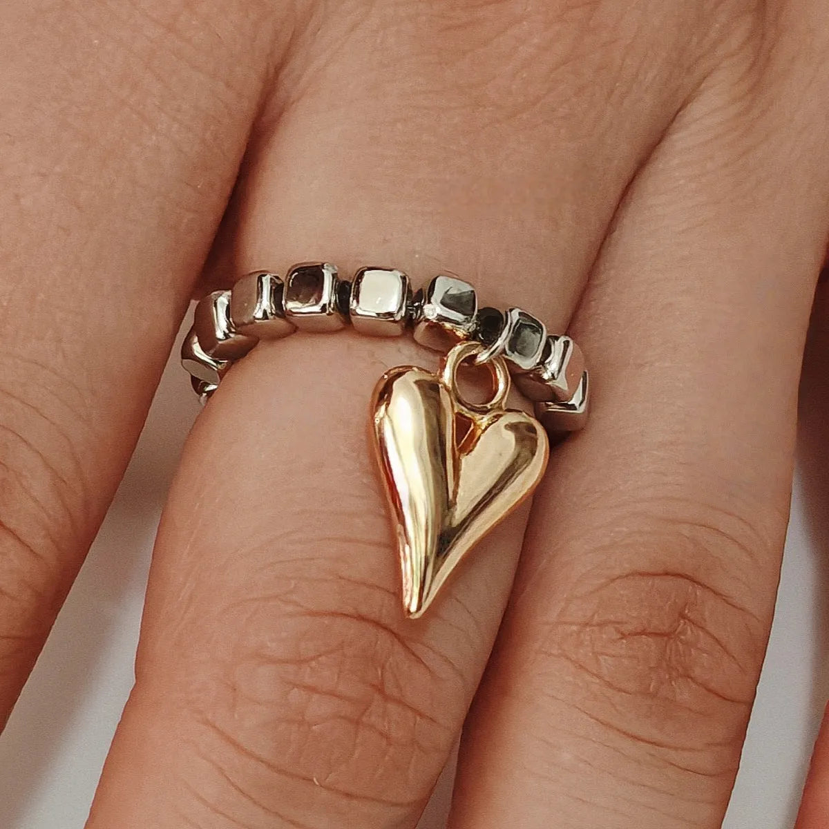 Handmade beaded elastic string love ring with geometric heart design in gold or white colours