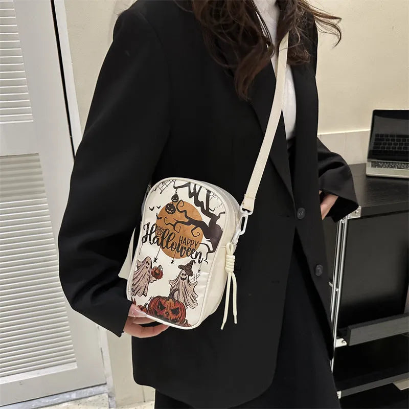 Black Halloween-themed mini crossbody bag with cartoon pumpkin, ghost, and bat prints.