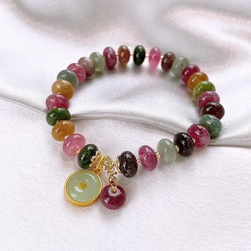 Colourful natural tourmaline abacus bead bracelet with a rabbit pendant charm.