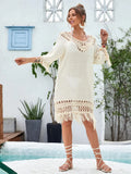 Apricot coloured hand-crocheted long beach dress for women on a hanger.