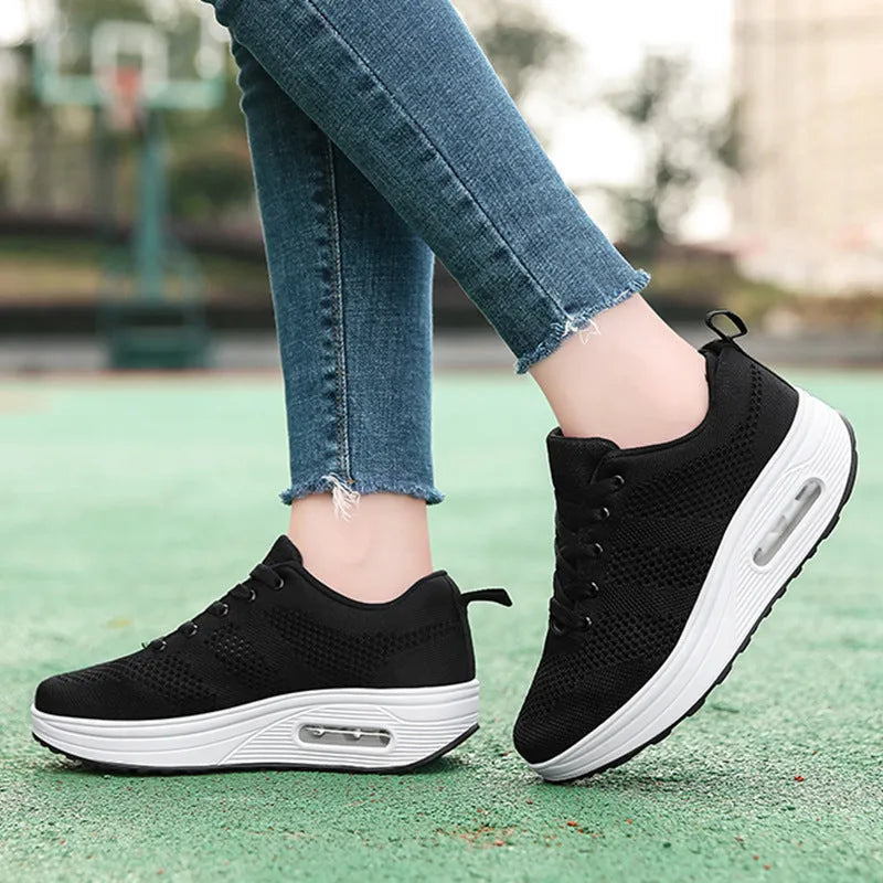 Women's platform casual shoes in black with a flyknit upper, T-shaped strap, and vulcanised sole.