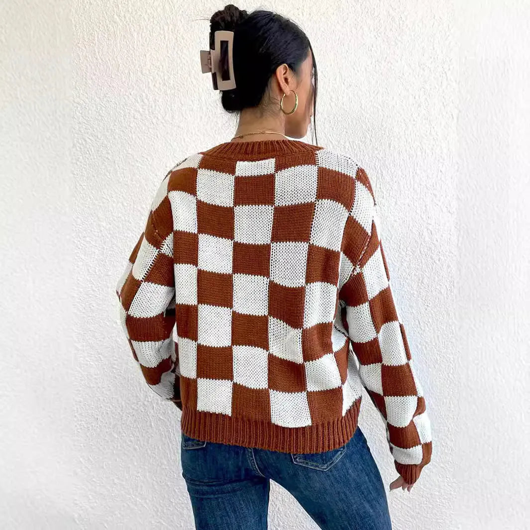 Dark brown loose plaid pullover sweater with a chessboard pattern and long sleeves.