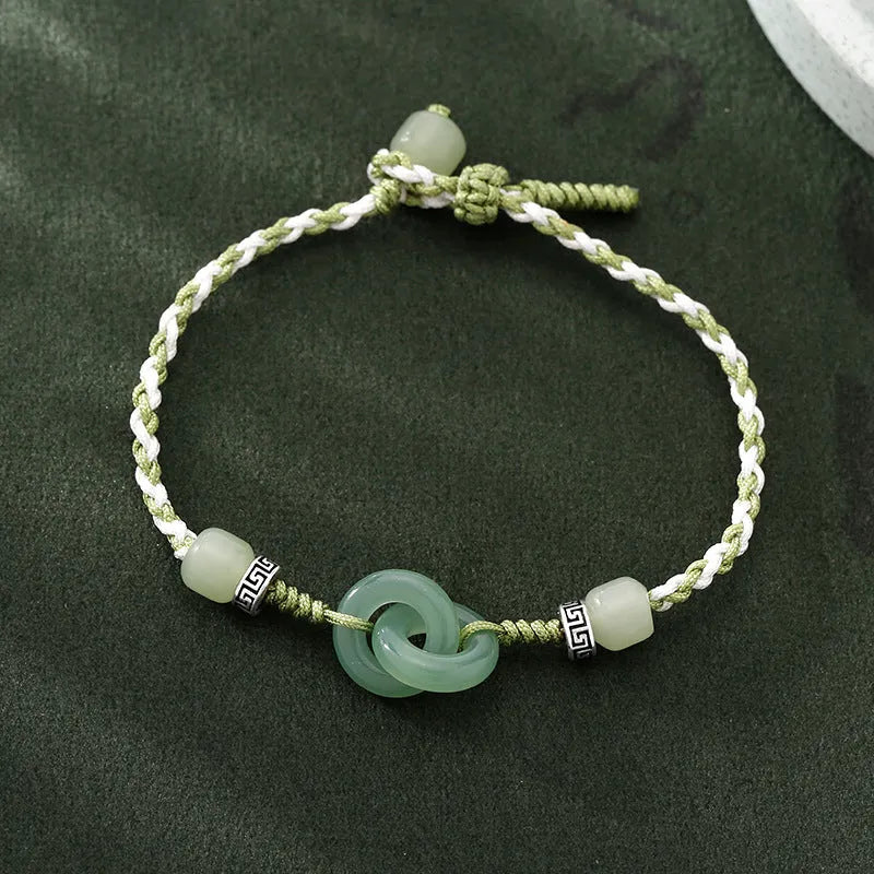 Women's copper bracelet with jade peace buckle and ethnic woven double-ring strap.