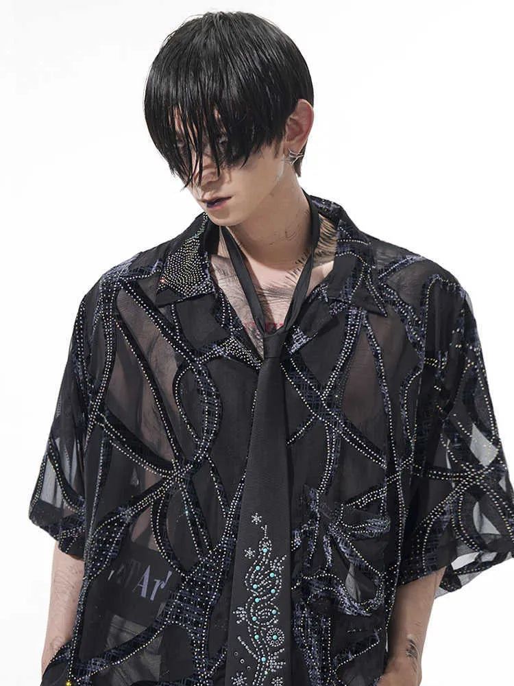 Man's black and grey short-sleeved shirt with translucent snake pattern, loose fit with lapel collar.