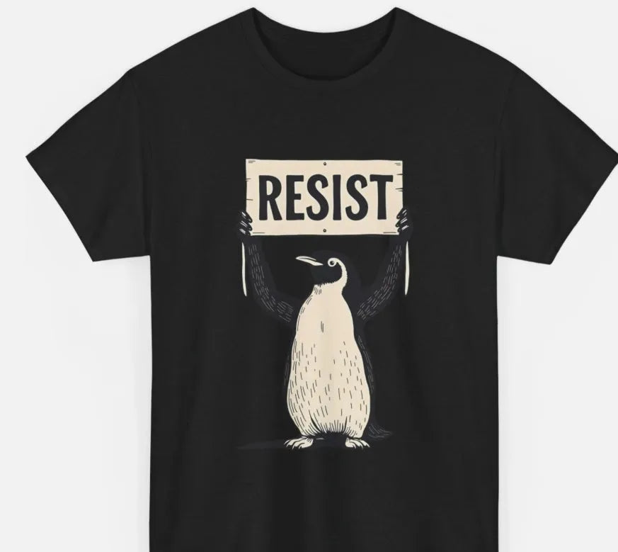 A loose-fitting black cotton T-shirt with short sleeves and a round neck on a hanger.