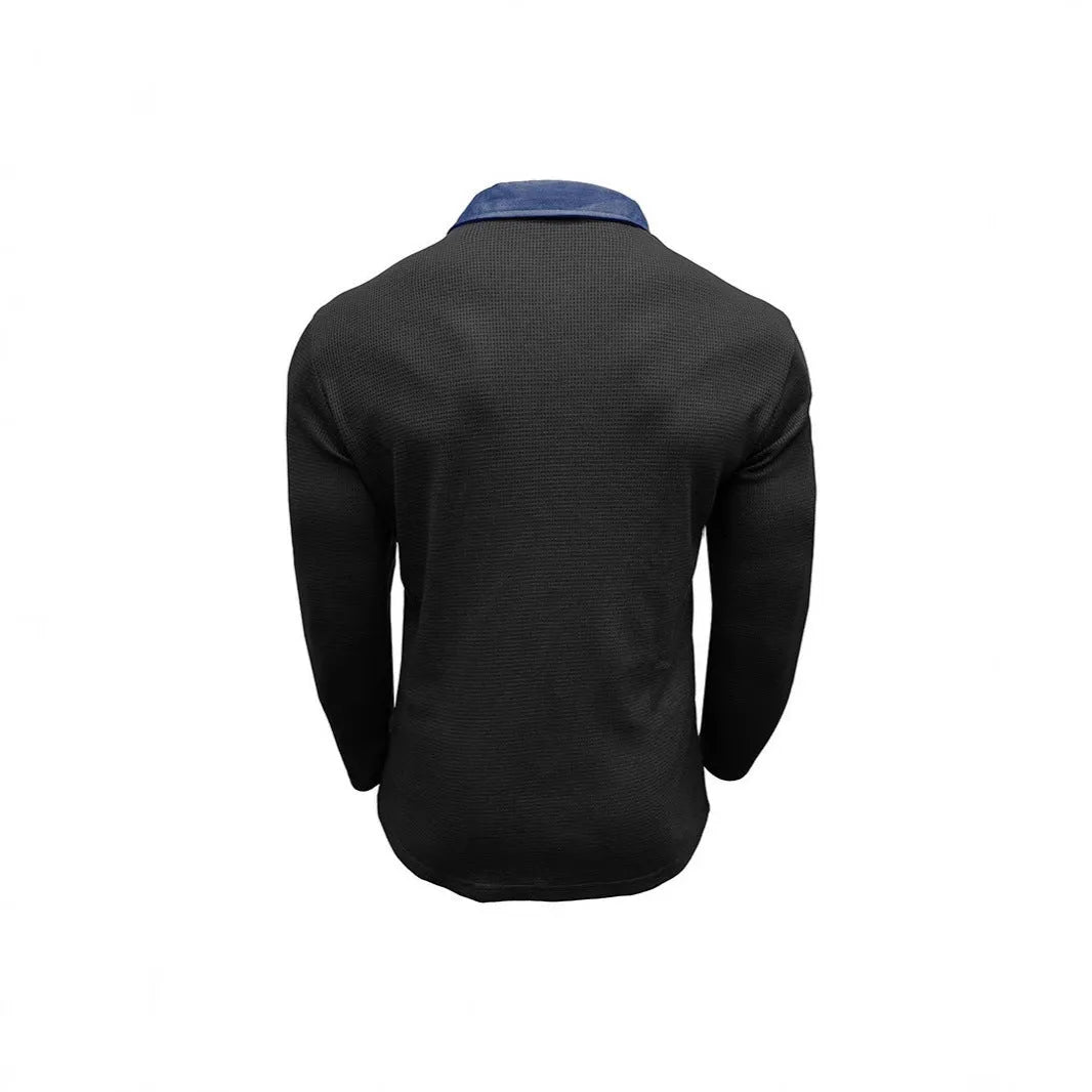 Man wearing a long-sleeved waffle-textured polo shirt in a loose fit, shown in a dark colour.