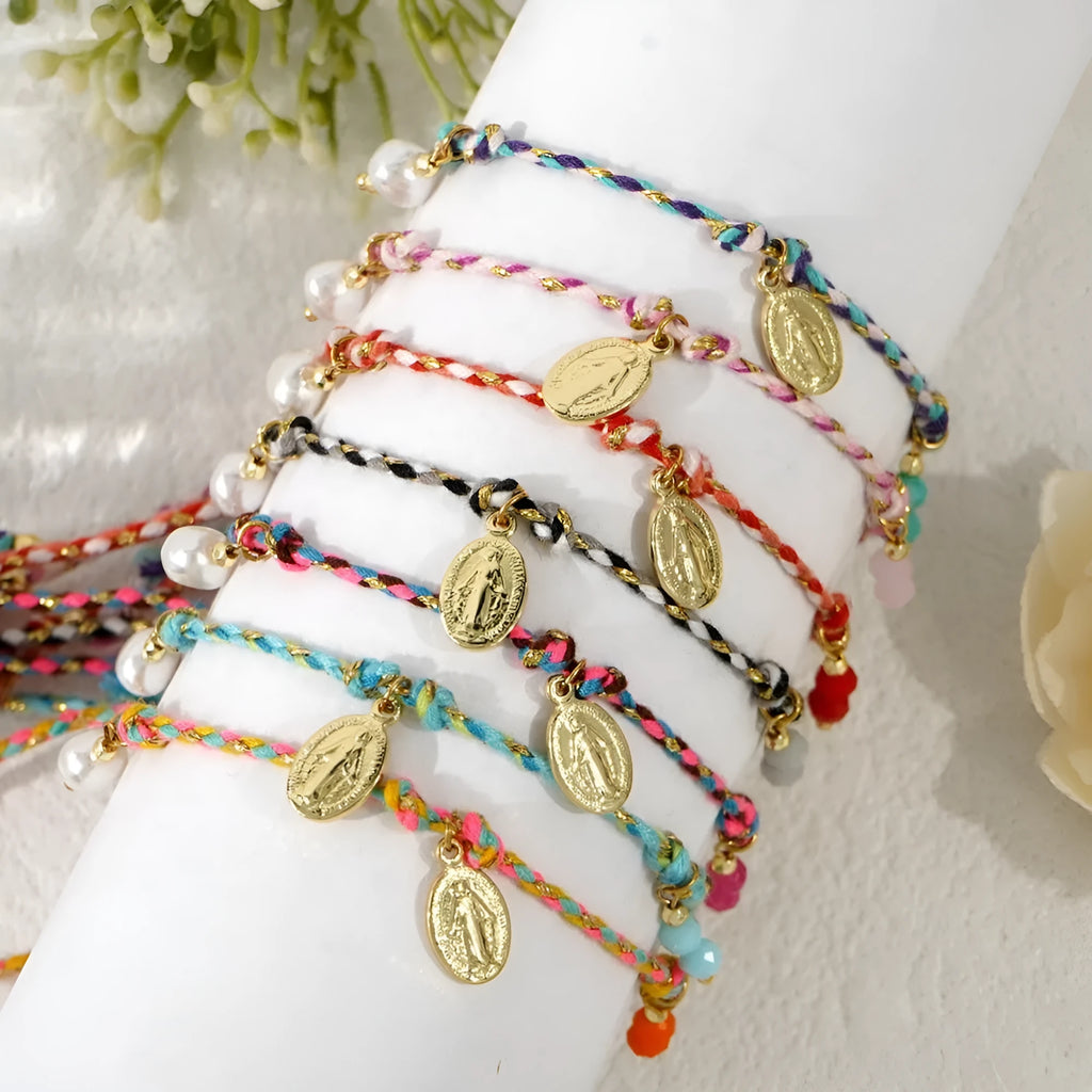 Close-up of a hand-woven ethnic style bracelet for women made from colourful braided rope, showing the strap tag detail.