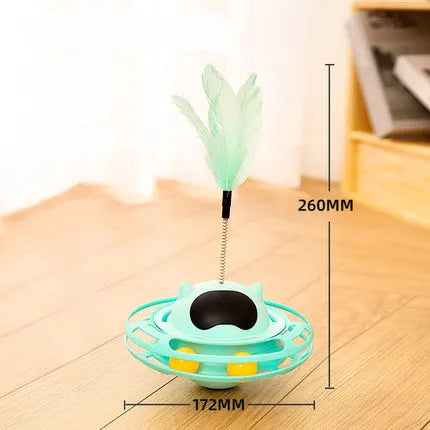 Pink cat tumbler turntable toy with a colourful baton on a flat surface.