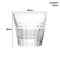 Clear whiskey shot glass with thick base and crystal design holding amber liquid
