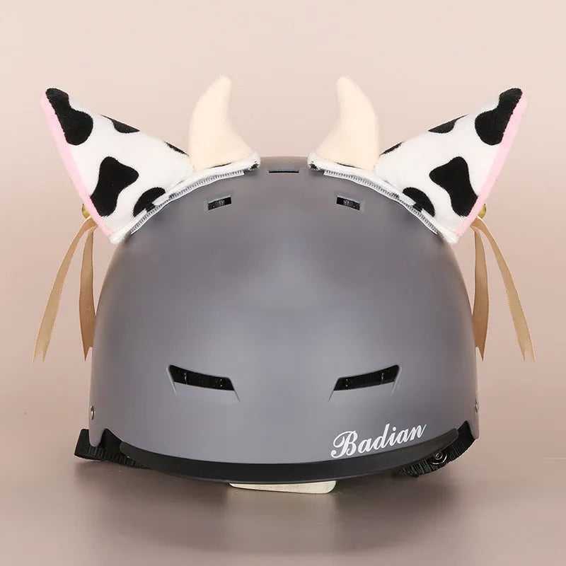Plush cartoon-themed cover set on a medium motorcycle helmet with soft ear decorations.
