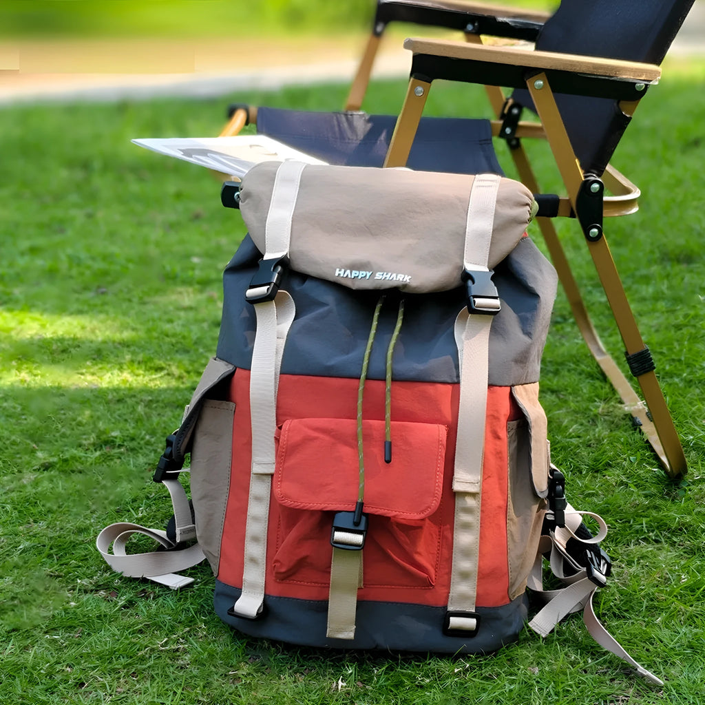 Orange and green outdoor backpack with multiple compartments and air pillow belt system