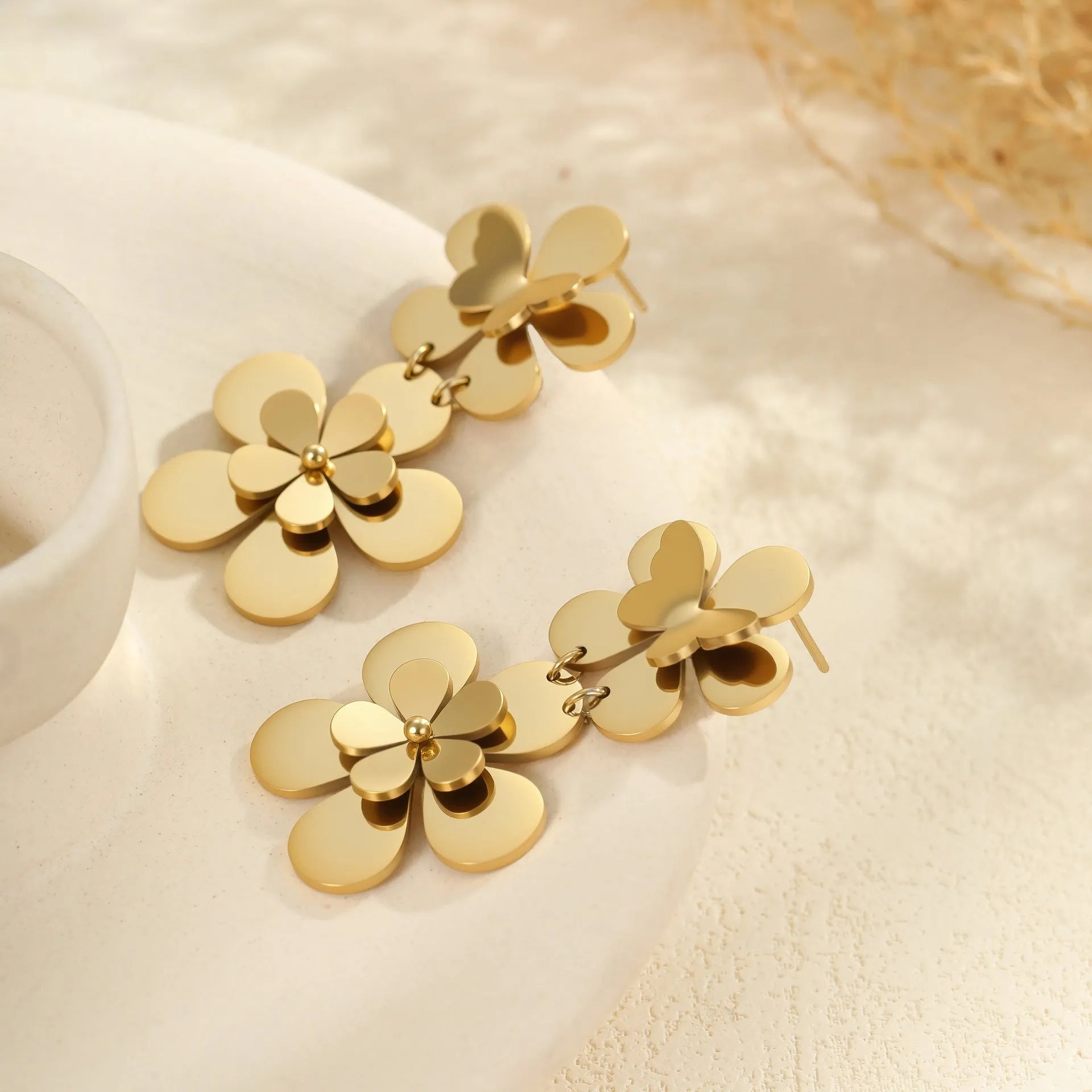 Gold flower butterfly earrings for women with geometric design on stainless steel.