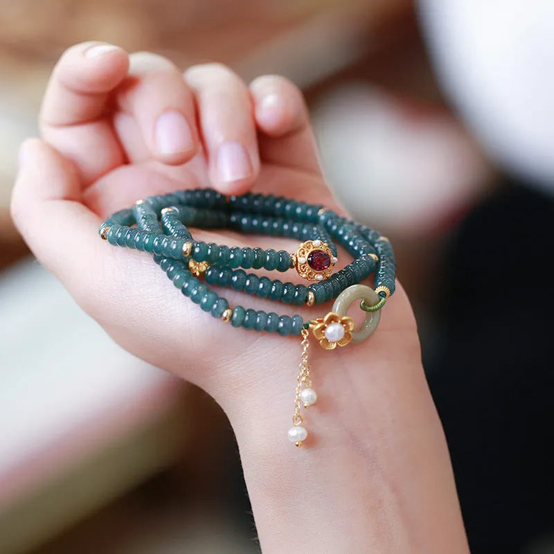 Blue water jade abacus bead bracelet with three silver rings and tourmaline pearls