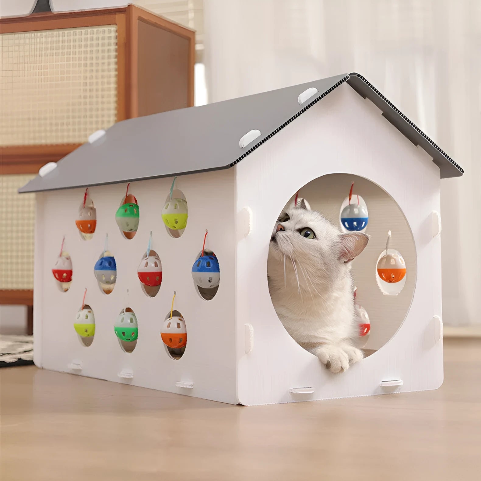 Plastic house-shaped cat scratch board integrated with a cat nest, tunnel, and bell ball toy.