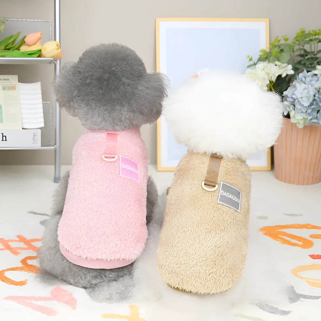 A blue coral fleece pet jacket for dogs or cats with a pull-ring fastening, laid flat.