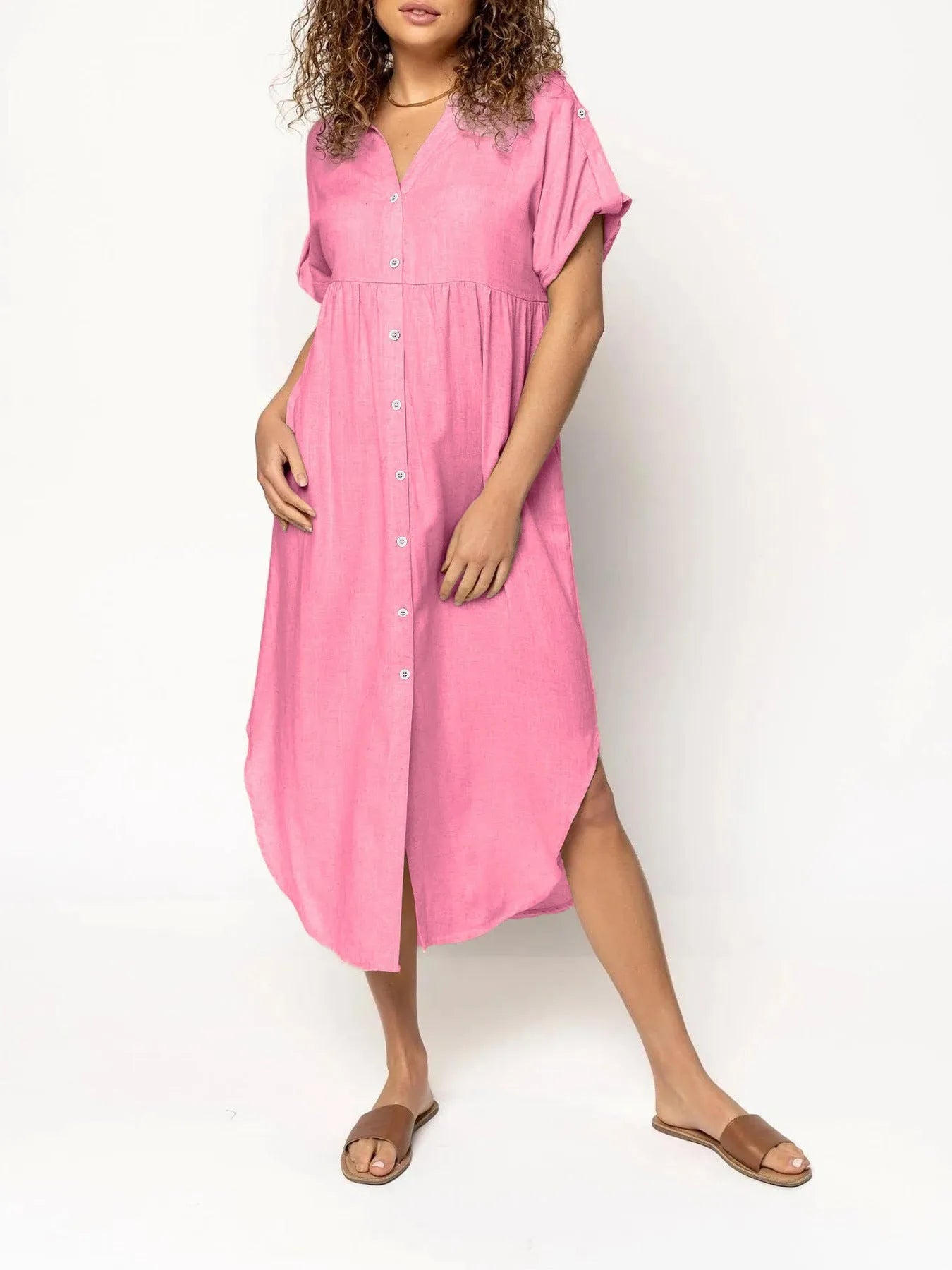 A solid colour mid-length casual dress with a button-down front and regular sleeves on a hanger.